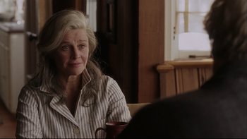Movie still from “Away from Her” (2006), directed by Sarah Polley – An older woman sitting at a table in a room; Close Up shot, Over the shoulder angle