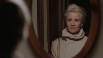 Movie still from “Away from Her” (2006), directed by Sarah Polley – An older woman looking in the mirror in front of a mirror; Close Up shot, Over the shoulder angle