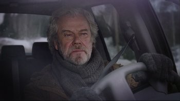 Movie still from “Away from Her” (2006), directed by Sarah Polley – An older man sitting in the drivers seat of a car; Close Up shot, Low angle