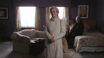 Movie still from “Away from Her” (2006), directed by Sarah Polley – An older woman standing in front of a bed; Medium shot, Over the shoulder angle