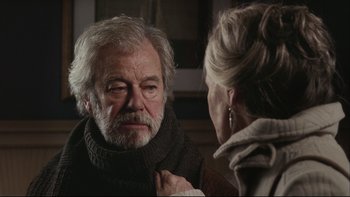 Movie still from “Away from Her” (2006), directed by Sarah Polley – An older man and a woman looking at each other in a mirror; Close Up shot, Over the shoulder angle