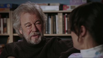 Movie still from “Away from Her” (2006), directed by Sarah Polley – An older man sitting in front of a young girl; Close Up shot, Over the shoulder angle