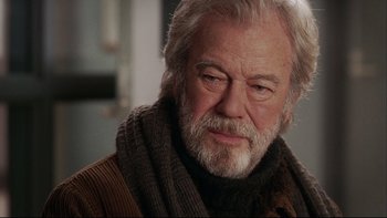 Movie still from “Away from Her” (2006), directed by Sarah Polley – An older man wearing a scarf and a sweater; Close Up shot, Over the shoulder angle