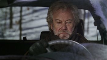 Movie still from “Away from Her” (2006), directed by Sarah Polley – An older man sitting in the drivers seat of a car; Close Up shot, Over the shoulder angle