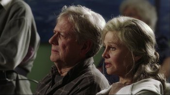 Movie still from “Away from Her” (2006), directed by Sarah Polley – An older man and a younger woman sitting next to each other; Close Up shot, Over the shoulder angle