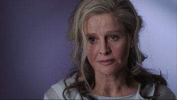 Movie still from “Away from Her” (2006), directed by Sarah Polley – An older woman with long gray hair looking at the camera; Close Up shot, Over the shoulder angle