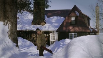 Movie still from “Away from Her” (2006), directed by Sarah Polley – A man walking in the snow in front of a house; Wide shot, High angle