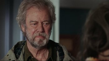 Movie still from “Away from Her” (2006), directed by Sarah Polley – An older man with a beard and a mustache; Close Up shot, Over the shoulder angle