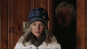 Movie still from “Away from Her” (2006), directed by Sarah Polley – An older woman wearing a plaid hat and a white jacket; Close Up shot, Over the shoulder angle