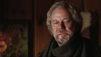 Movie still from “Away from Her” (2006), directed by Sarah Polley – An older man wearing a sweater and a scarf; Close Up shot, Low angle