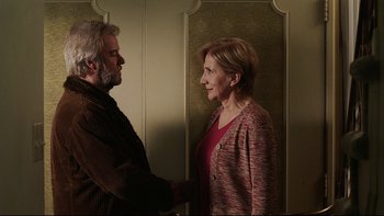 Movie still from “Away from Her” (2006), directed by Sarah Polley – An older man and a younger woman shaking hands; Medium shot, Over the shoulder angle