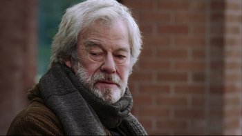 Movie still from “Away from Her” (2006), directed by Sarah Polley – An older man with a gray beard wearing a scarf; Close Up shot, Over the shoulder angle