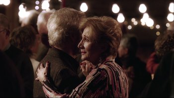 Movie still from “Away from Her” (2006), directed by Sarah Polley – An older man and a woman are dancing together; Close Up shot, Over the shoulder angle