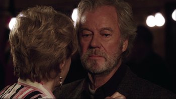 Movie still from “Away from Her” (2006), directed by Sarah Polley – An older man and a younger woman looking into each others eyes; Close Up shot, Over the shoulder angle
