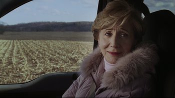 Movie still from “Away from Her” (2006), directed by Sarah Polley – An older woman sitting in the passenger seat of a car; Close Up shot, Over the shoulder angle