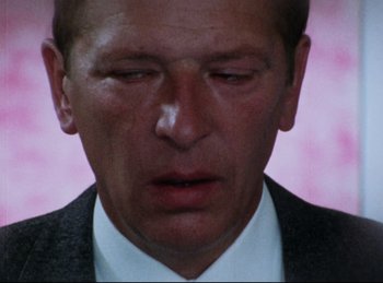 Movie still from “Baal” (1970), directed by Volker Schlöndorff – A person wearing a suit and tie; Close Up shot, Low angle