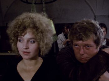 Movie still from “Baal” (1970), directed by Volker Schlöndorff – A man and a woman sitting next to each other; Close Up shot, Over the shoulder angle