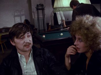 Movie still from “Baal” (1970), directed by Volker Schlöndorff – A man and a woman sitting next to a pool table; Medium shot, Over the shoulder angle
