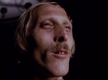 Movie still from “Baal” (1970), directed by Volker Schlöndorff – A person with long hair and a mustache; Close Up shot, Low angle