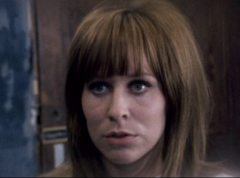 Movie still from “Baal” (1970), directed by Volker Schlöndorff – A person with long brown hair; Close Up shot, Low angle