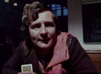 Movie still from “Baal” (1970), directed by Volker Schlöndorff – A man sitting on a bus holding a phone; Close Up shot, Over the shoulder angle