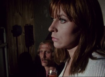 Movie still from “Baal” (1970), directed by Volker Schlöndorff – A woman and a man standing next to each other in a room; Close Up shot, Low angle