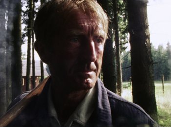 Movie still from “Baal” (1970), directed by Volker Schlöndorff – A person in the woods; Close Up shot, Low angle