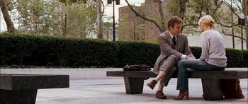 Movie still from “Stay” (2005), directed by Marc Forster – A man sitting on top of a bench on a sidewalk; Wide shot, Over the shoulder angle