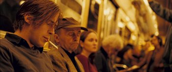Movie still from “Stay” (2005), directed by Marc Forster – A group of people sitting next to each other on a train; Close Up shot, Over the shoulder angle