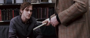 Movie still from “Stay” (2005), directed by Marc Forster – A man holding a pair of chopsticks while another man watches; Medium shot, Over the shoulder angle