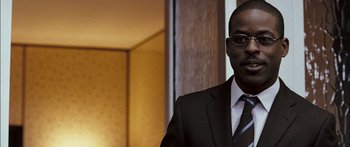 Movie still from “Stay” (2005), directed by Marc Forster – A man in a suit and tie standing in front of a wall; Close Up shot, Over the shoulder angle