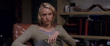 Movie still from “Stay” (2005), directed by Marc Forster – A woman sitting in a chair in front of a bookshelf; Close Up shot, Over the shoulder angle