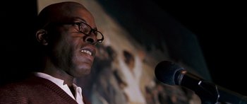 Movie still from “Stay” (2005), directed by Marc Forster – A person speaking on a microphone; Close Up shot, Low angle