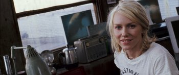 Movie still from “Stay” (2005), directed by Marc Forster – A woman is posing for a picture in front of an old radio; Close Up shot, Over the shoulder angle