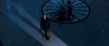 Movie still from “Stay” (2005), directed by Marc Forster – A man standing in front of a clock at night; Wide shot, High angle
