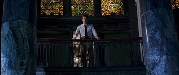 Movie still from “Stay” (2005), directed by Marc Forster – A man standing on top of a railing in front of stained glass windows; Wide shot, Low angle