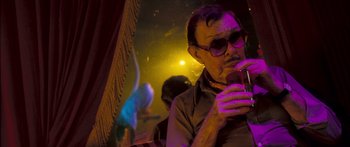 Movie still from “Stay” (2005), directed by Marc Forster – A man with glasses is looking at his cell phone; Close Up shot, Low angle