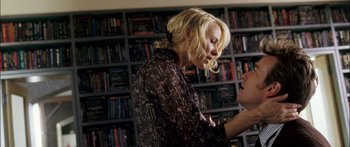 Movie still from “Stay” (2005), directed by Marc Forster – A woman in a black shirt is looking at her cell phone; Medium shot, Low angle