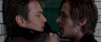 Movie still from “Stay” (2005), directed by Marc Forster – Two men face each other with one of them holding his mouth open; Close Up shot, Over the shoulder angle