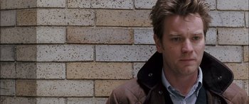 Movie still from “Stay” (2005), directed by Marc Forster – A person standing in front of a brick wall; Close Up shot, Over the shoulder angle