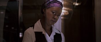 Movie still from “Stay” (2005), directed by Marc Forster – A woman wearing a purple head scarf and a white shirt; Close Up shot, Low angle