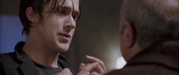 Movie still from “Stay” (2005), directed by Marc Forster – A man is talking to another man in a dark room; Close Up shot, Over the shoulder angle