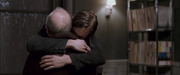 Movie still from “Stay” (2005), directed by Marc Forster – A man and a woman hugging in a dark room; Medium shot, Over the shoulder angle