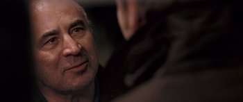 Movie still from “Stay” (2005), directed by Marc Forster – An older man looking into a mirror with his hand on his face; Close Up shot, Over the shoulder angle