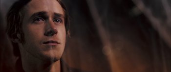 Movie still from “Stay” (2005), directed by Marc Forster – A man's face in a dark room; Close Up shot, Over the shoulder angle