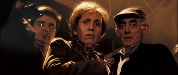 Movie still from “Stay” (2005), directed by Marc Forster – A woman and two men standing next to each other; Close Up shot, Low angle