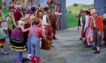 Movie still from “Babes in Toyland” (1961), directed by Jack Donohue – A group of people dressed up in costumes; Wide shot, High angle