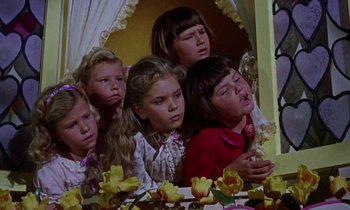 Movie still from “Babes in Toyland” (1961), directed by Jack Donohue – A group of children sitting in front of a bed; Medium shot, Low angle