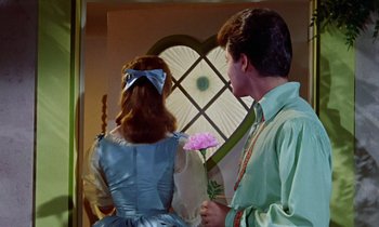 Movie still from “Babes in Toyland” (1961), directed by Jack Donohue – A man and a woman dressed as alice and the mad hatter; Medium shot, Low angle