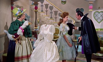 Movie still from “Babes in Toyland” (1961), directed by Jack Donohue – A group of people dressed up in costumes; Medium shot, Over the shoulder angle